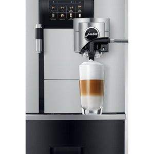 Cafetera Jura GIGA X3 Aluminium preparando un café latte con espuma cremosa.
